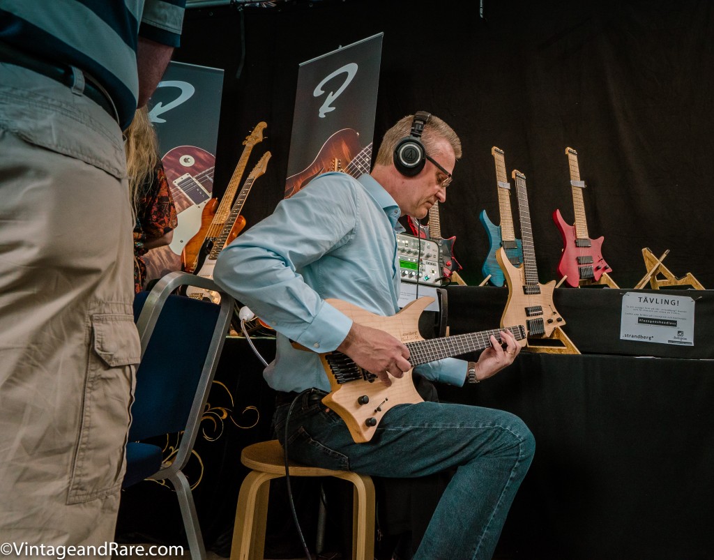 Gentleman trying out a luthier-built guitar. 